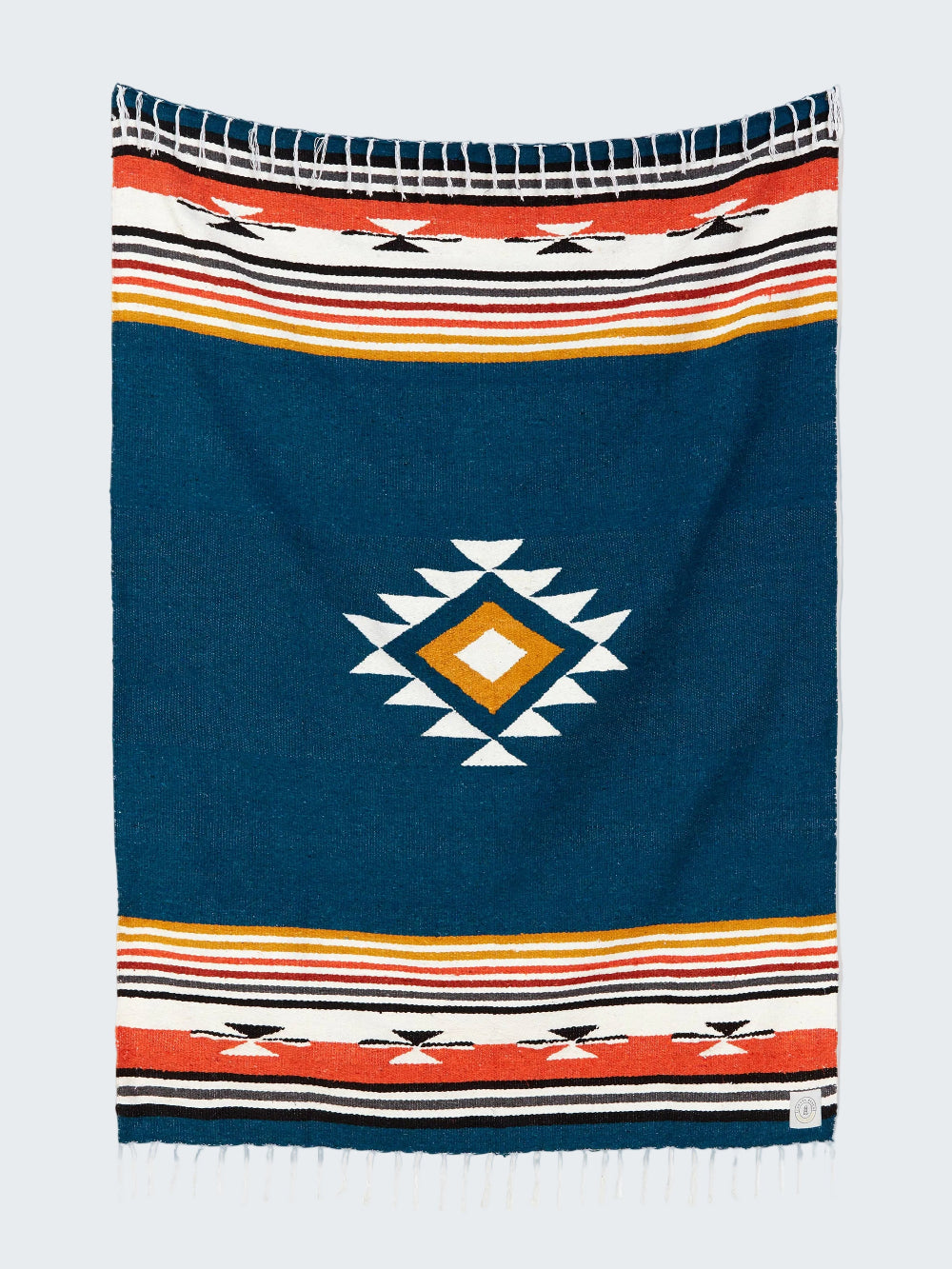 Navy blue blanket with geometric pattern and colorful stripes on a white background