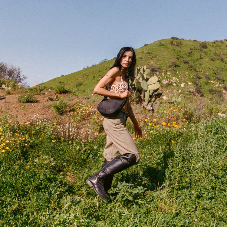 Woman in a natural setting with cacti and wildflowers