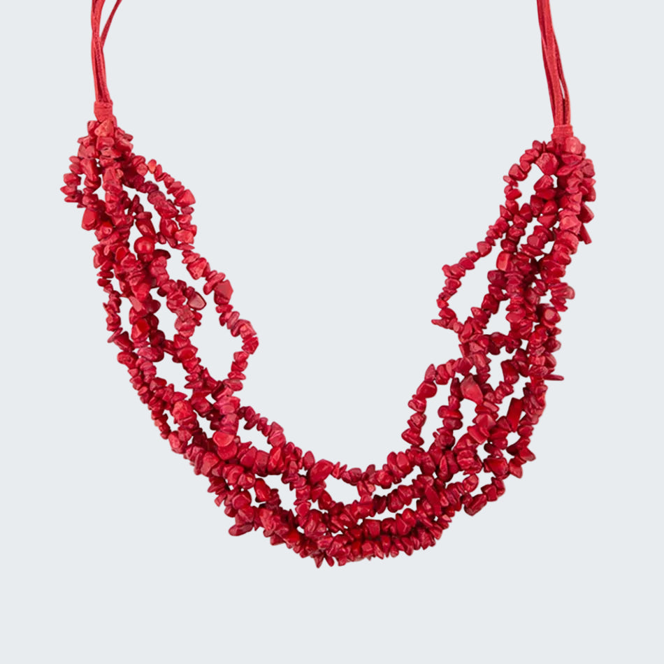 Red beaded necklace on a white background