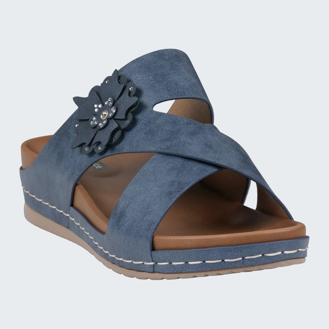 Blue sandal with a decorative flower on a white background