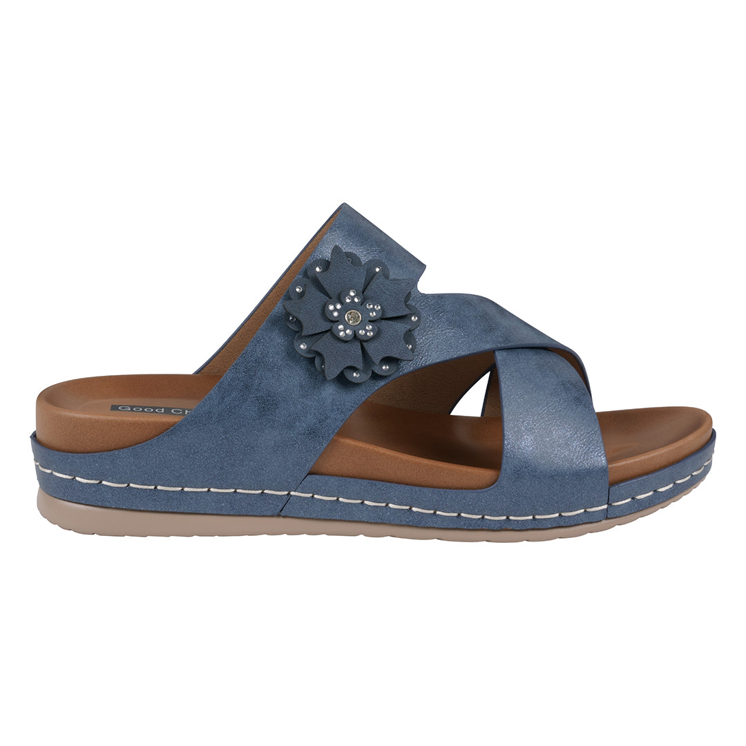Blue sandal with a flower detail on a white background
