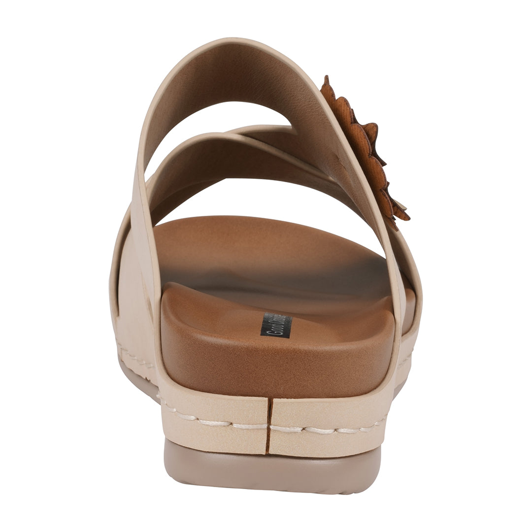 Beige sandal with a brown sole on a white background