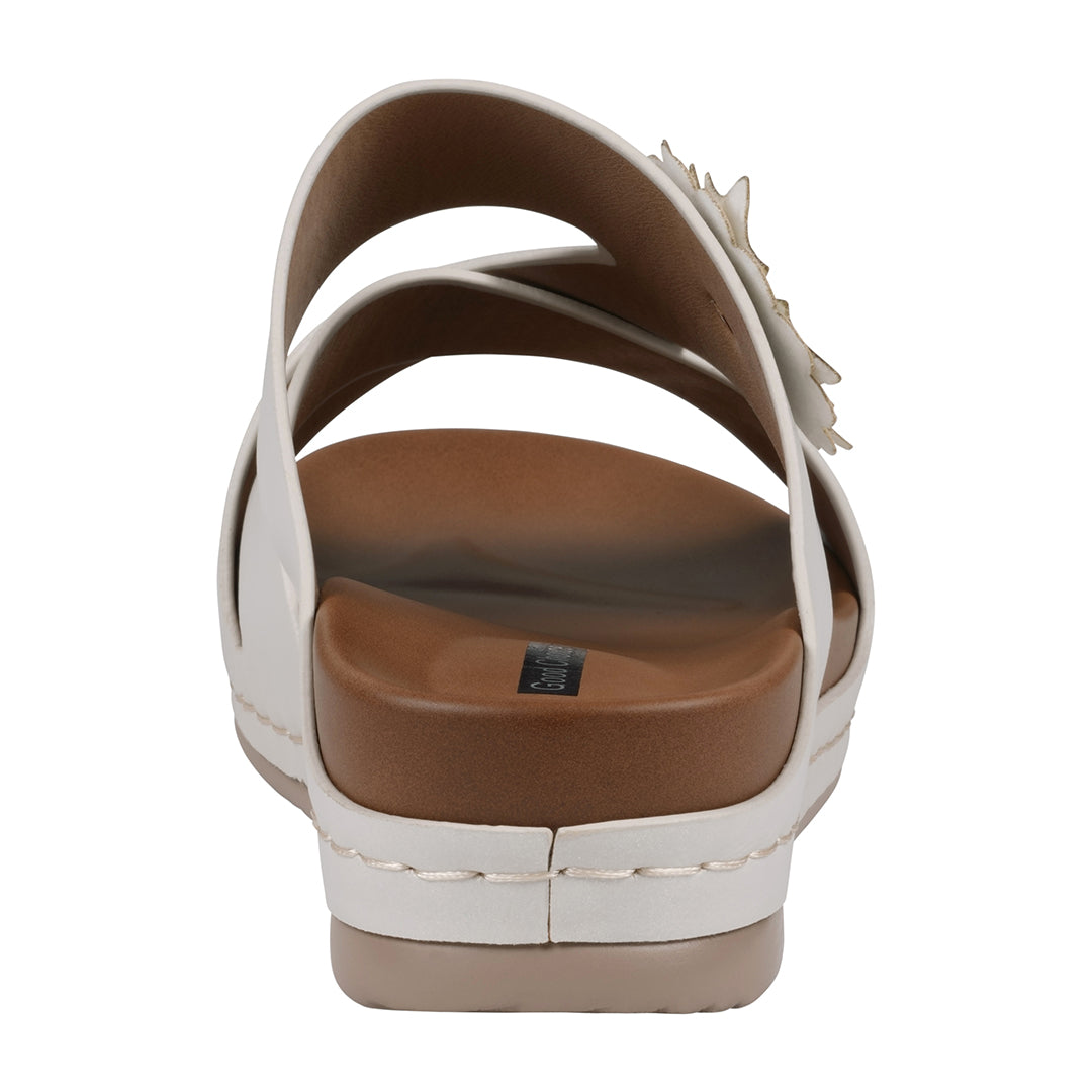 White sandal with brown sole on a white background