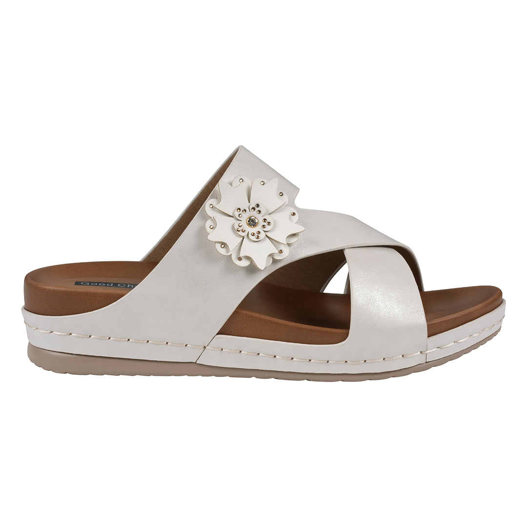 White sandal with a decorative flower on a white background