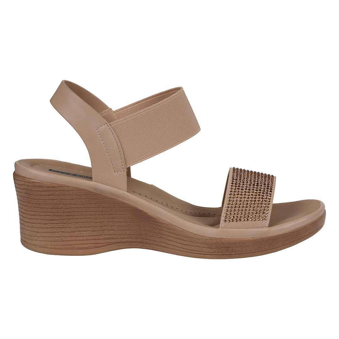 Beige wedge sandal with a textured strap on a white background