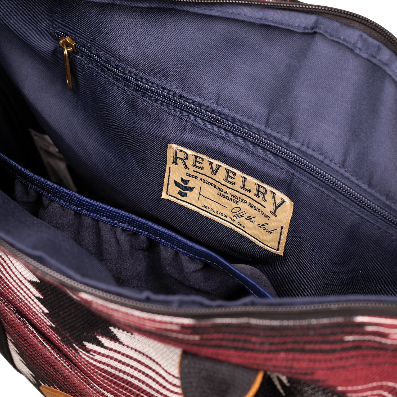 Navy blue bag with a visible 'Revelry' brand label