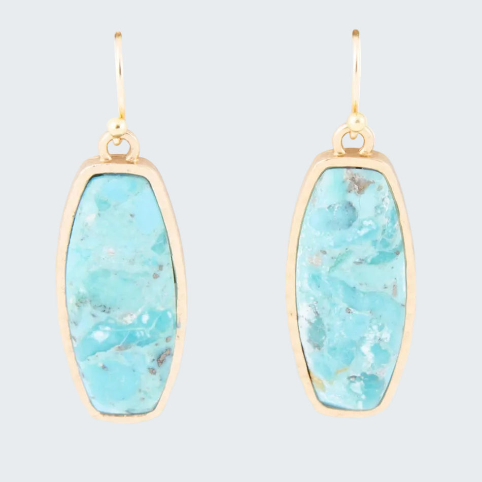 Turquoise stone earrings with gold frames on a white background