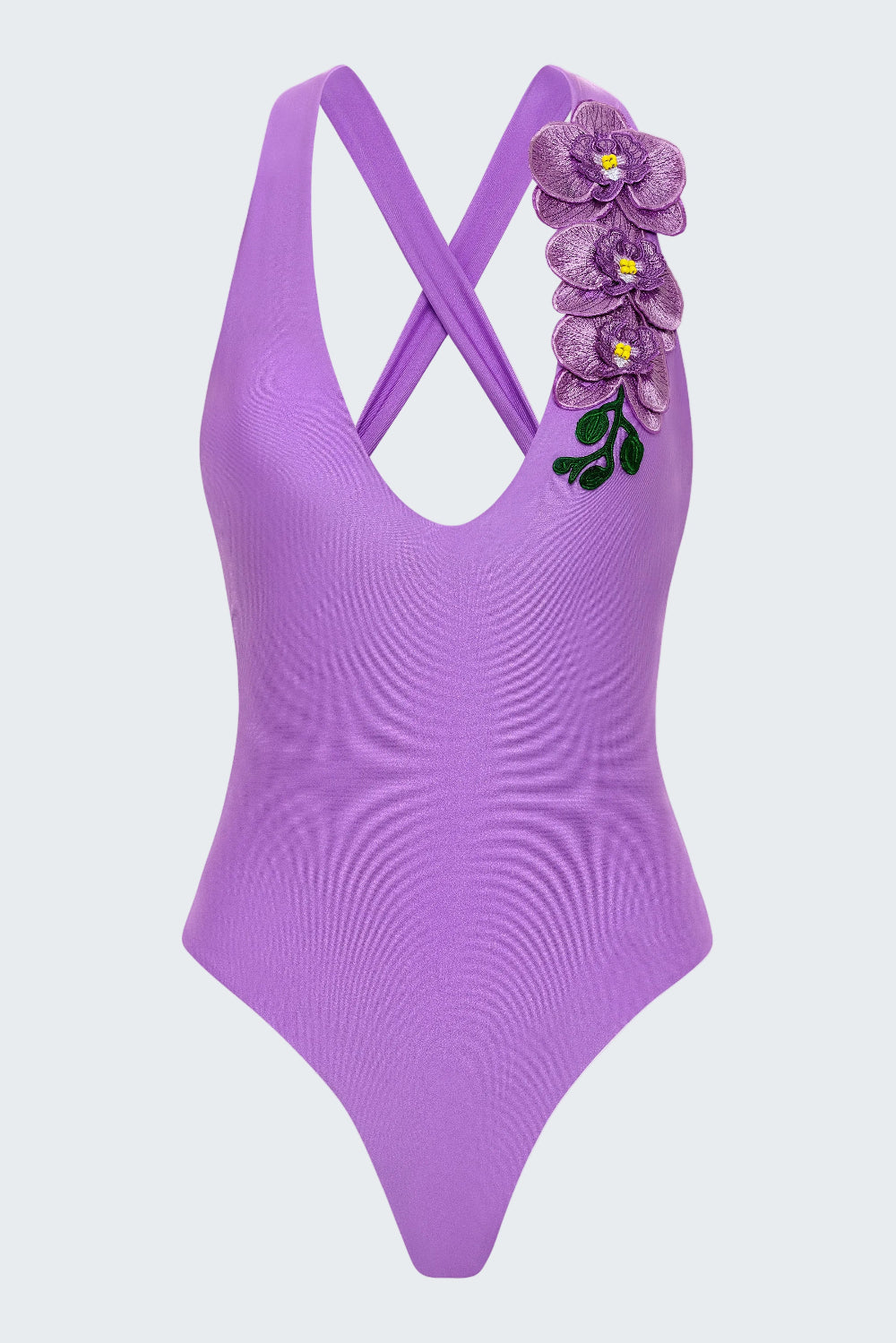 Purple swimsuit with floral design on a white background