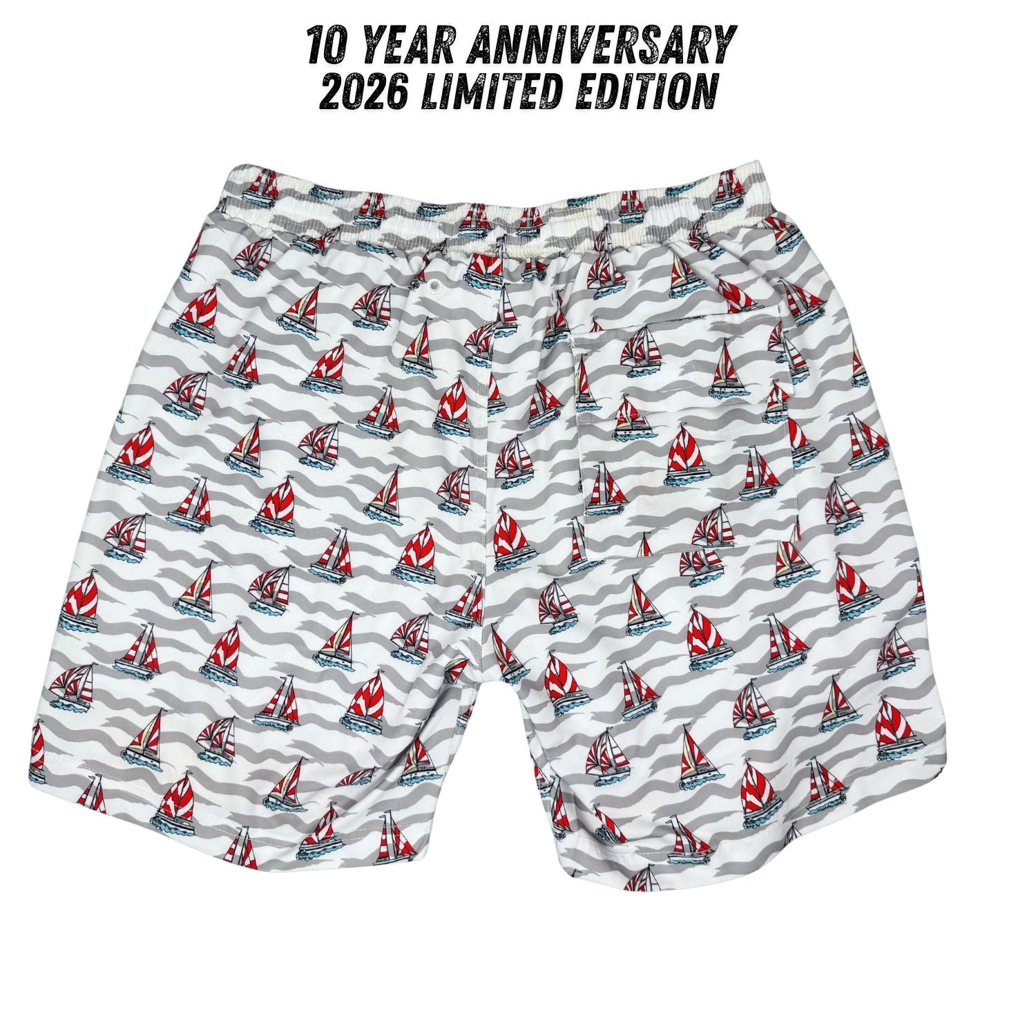 Shorts with sailboat pattern on a white background, labeled '10 Year Anniversary 2026 Limited Edition'.