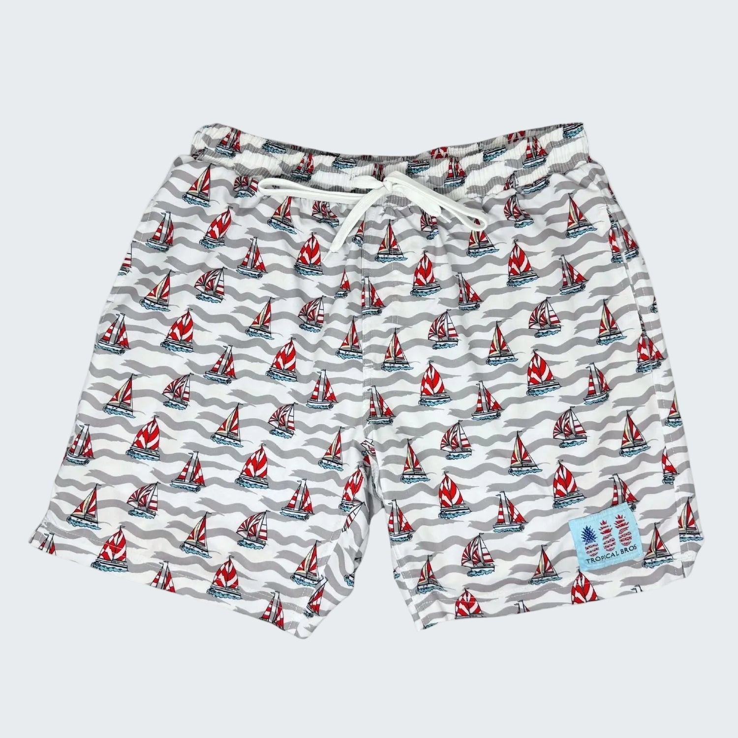Swim shorts with sailboat pattern on a white background, labeled '10 Year Anniversary 2026 Limited Edition'.
