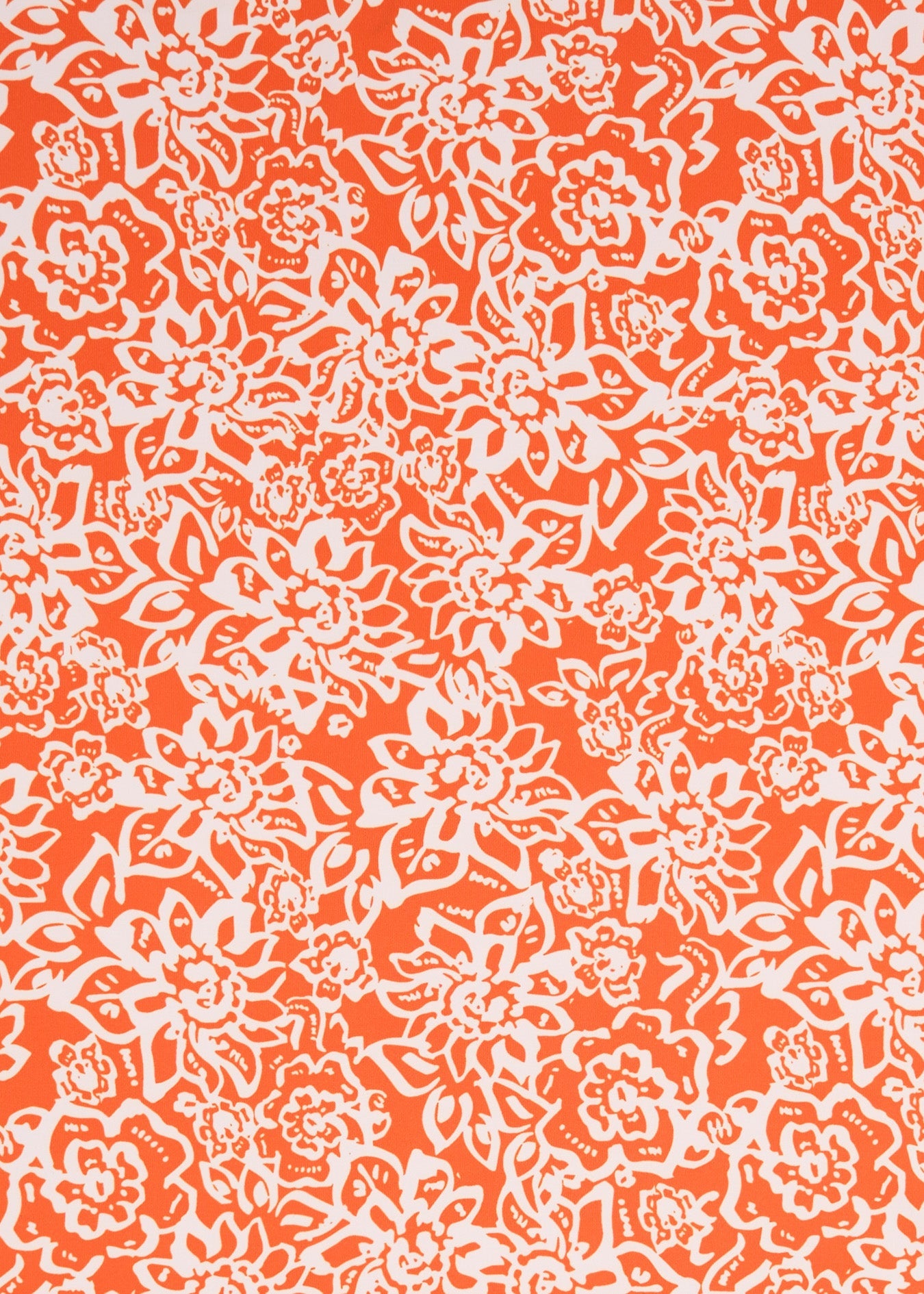 A close-up of a repeating floral pattern in bright orange and white, filling the entire frame.