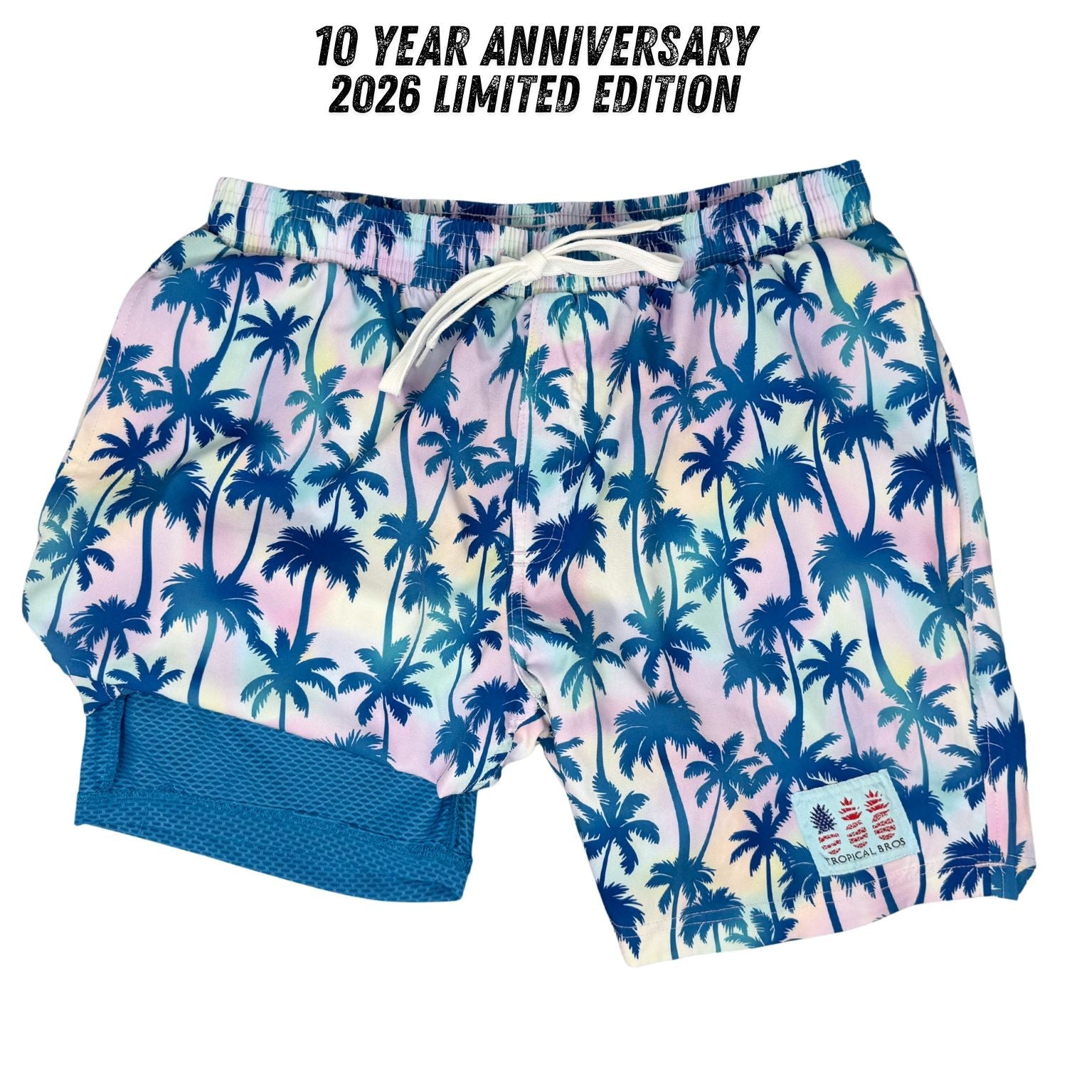 Swim shorts with palm tree pattern and 10 Year Anniversary text on a white background
