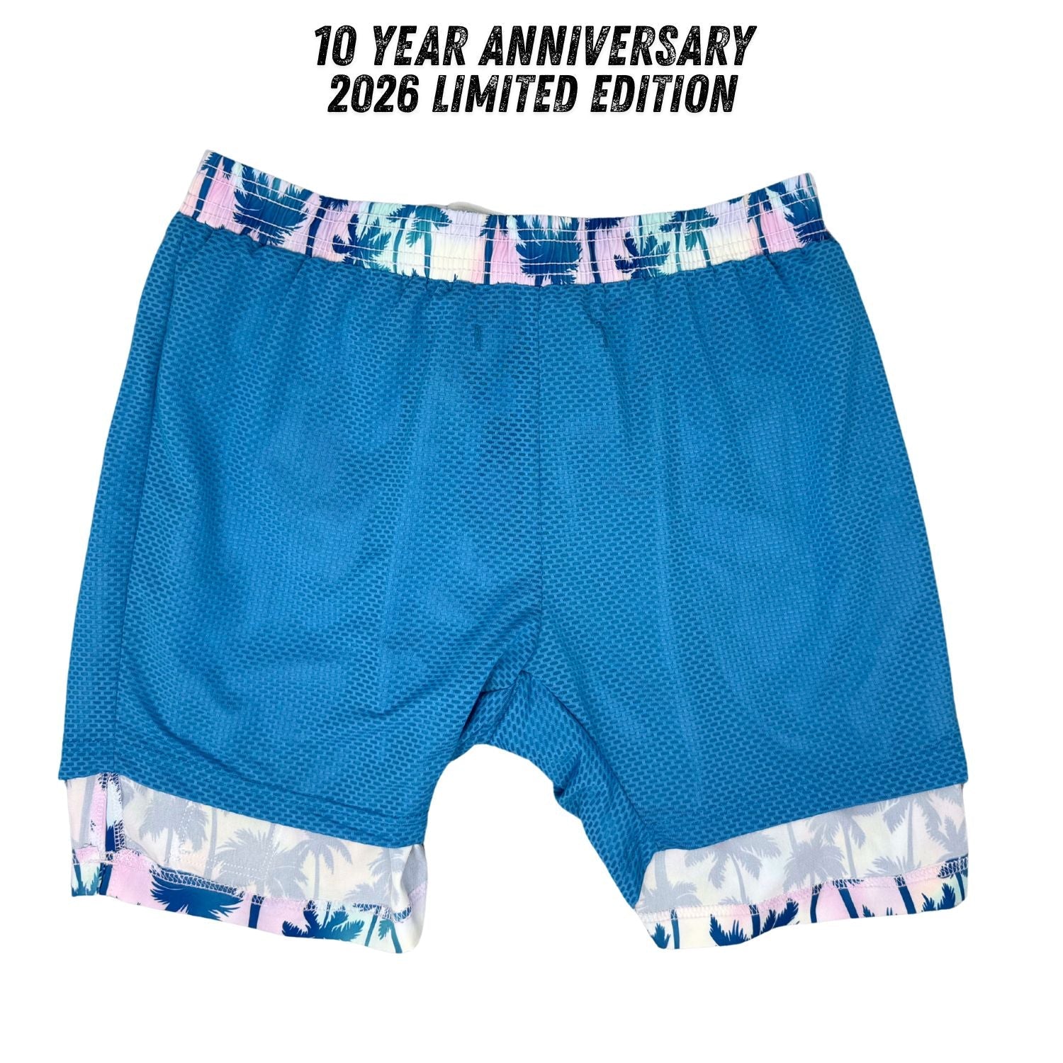 Blue athletic shorts with a colorful waistband and hem, labeled '10 Year Anniversary 2026 Limited Edition'.