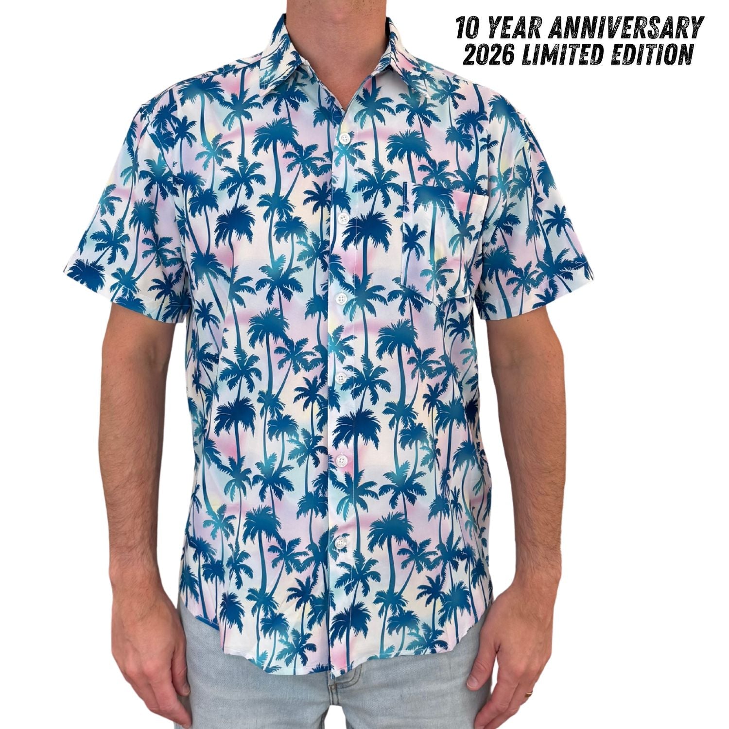 Person wearing a short-sleeve shirt with blue palm tree pattern on a white background