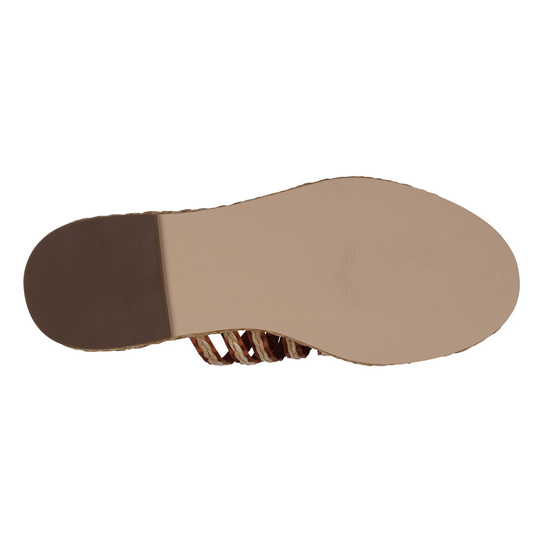 Bottom view of a sandal with a tan sole and brown insole on a white background