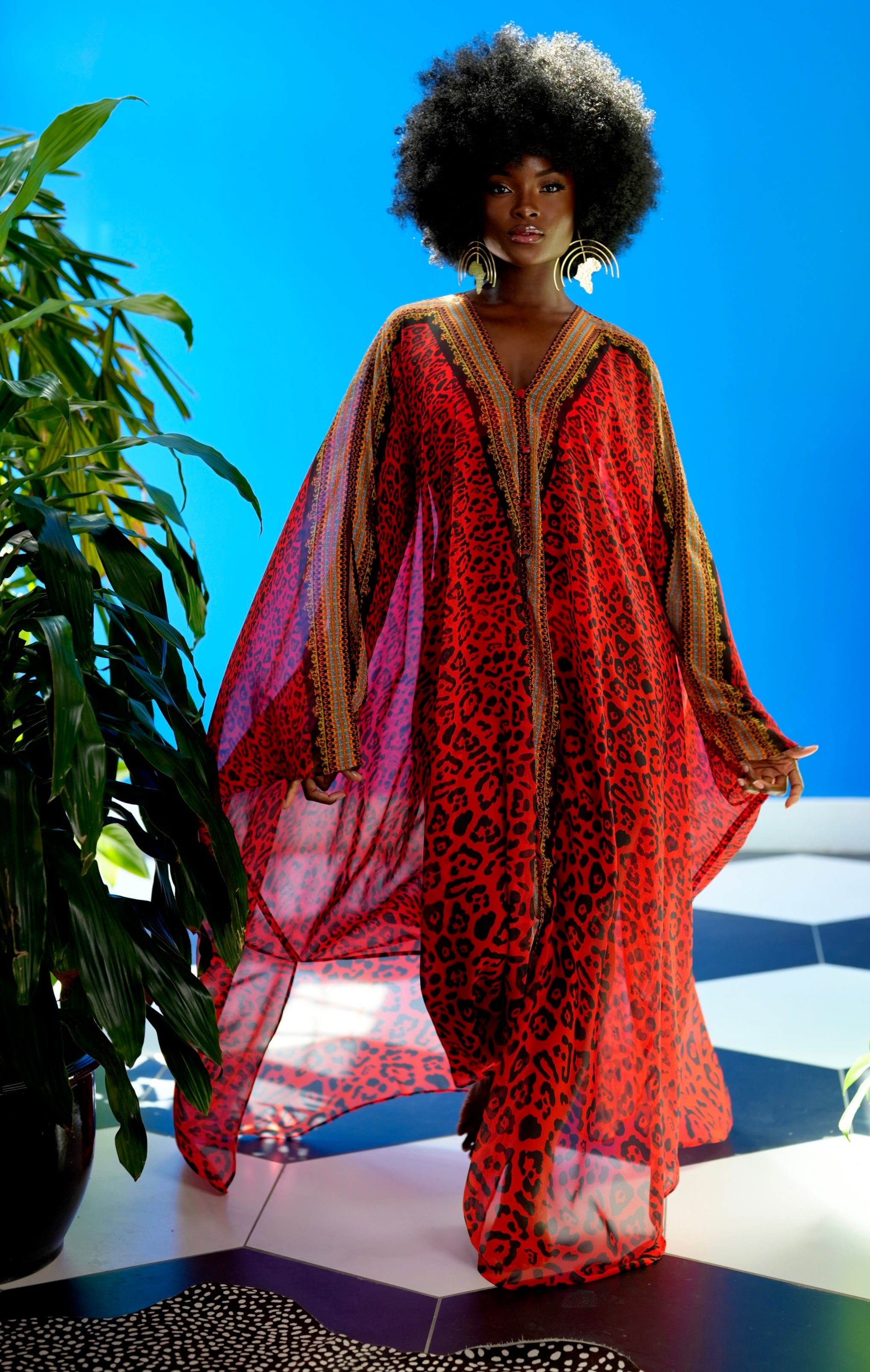 Woman wearing a red and gold outfit with a blue background
