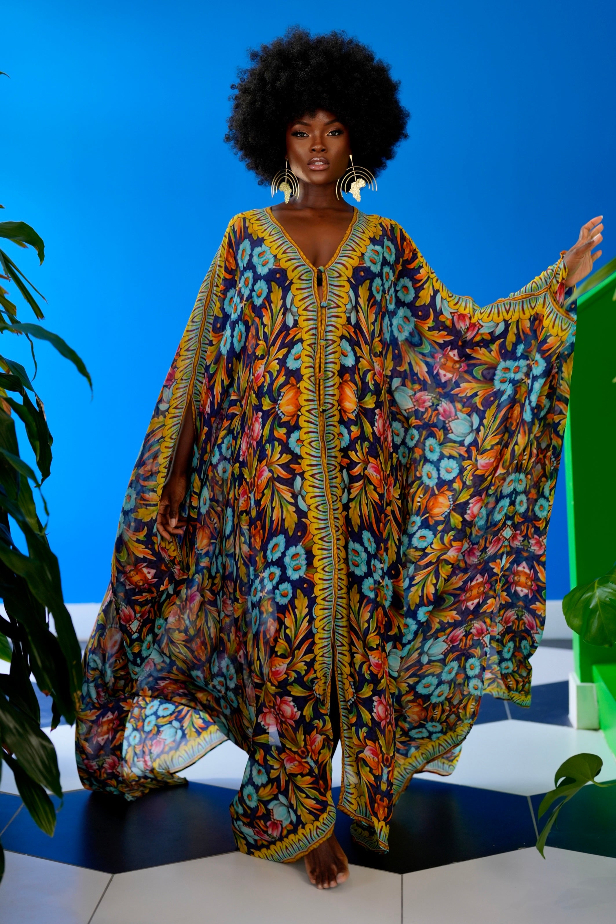 Woman wearing a colorful floral dress against a blue background