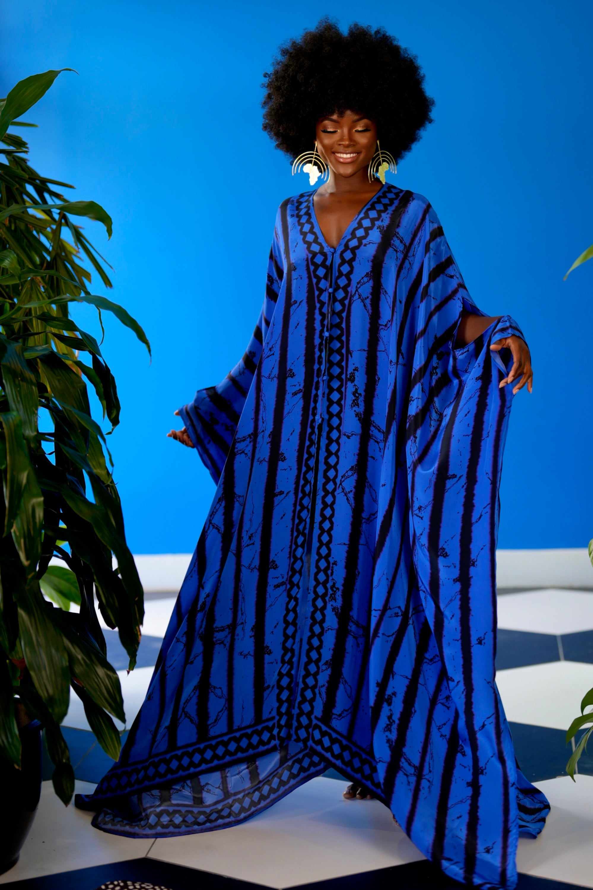 Woman wearing a blue patterned dress against a blue background