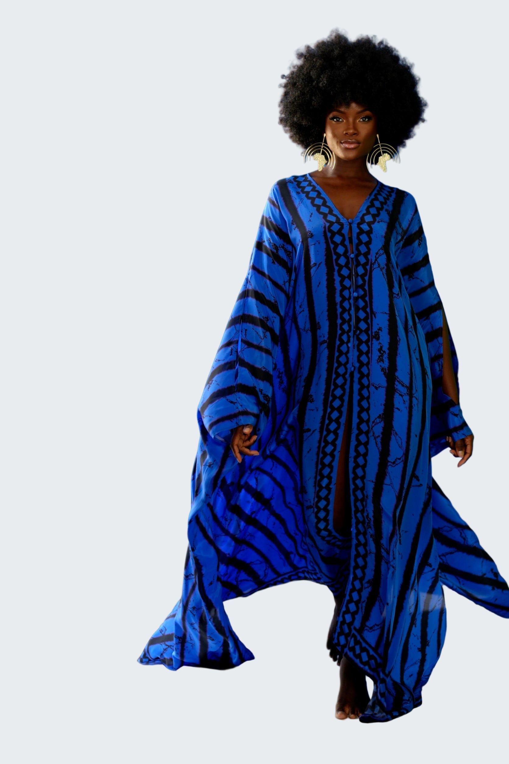 Woman wearing a blue patterned dress against a blue background