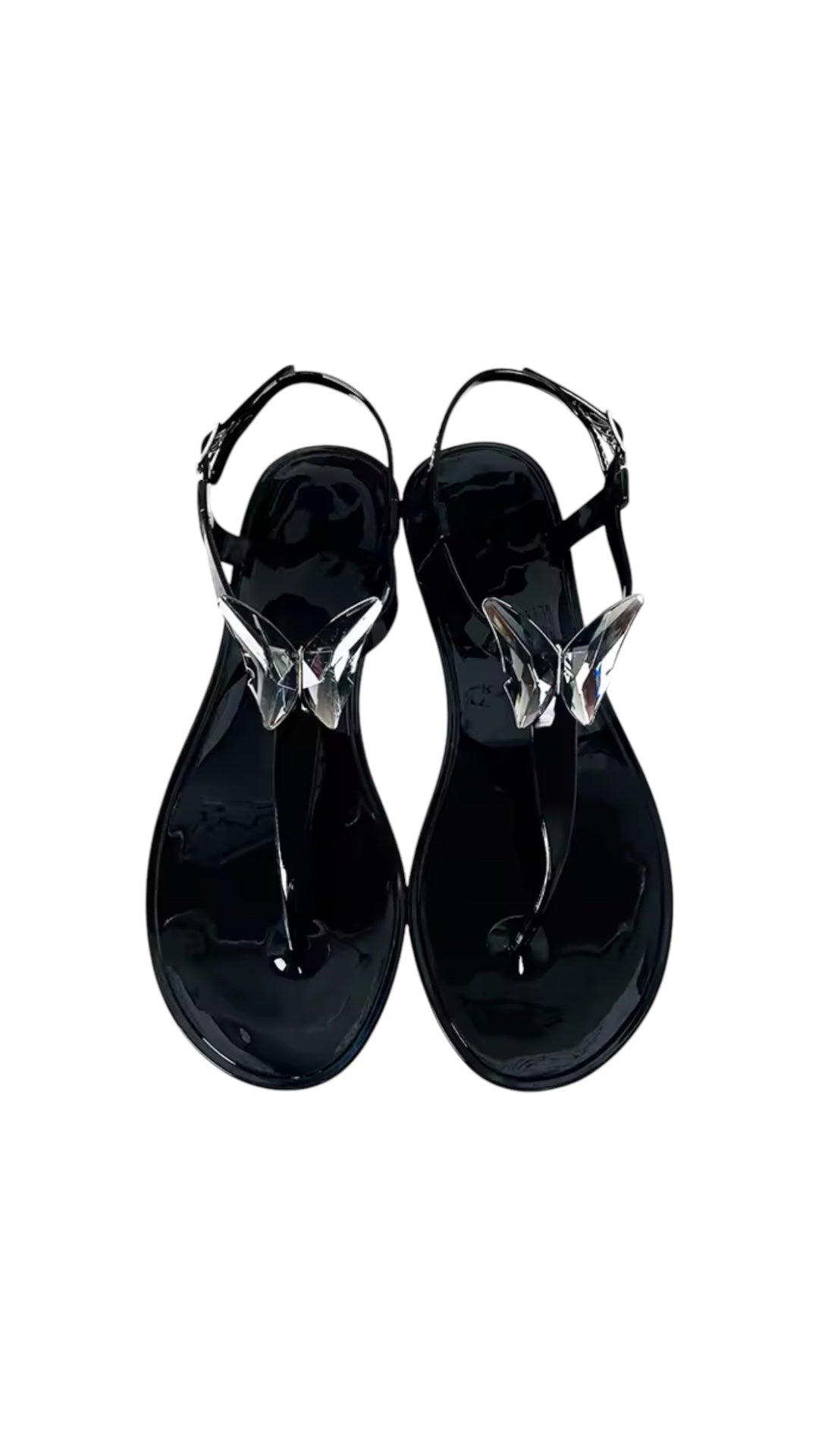 Black sandals with clear straps on a white background