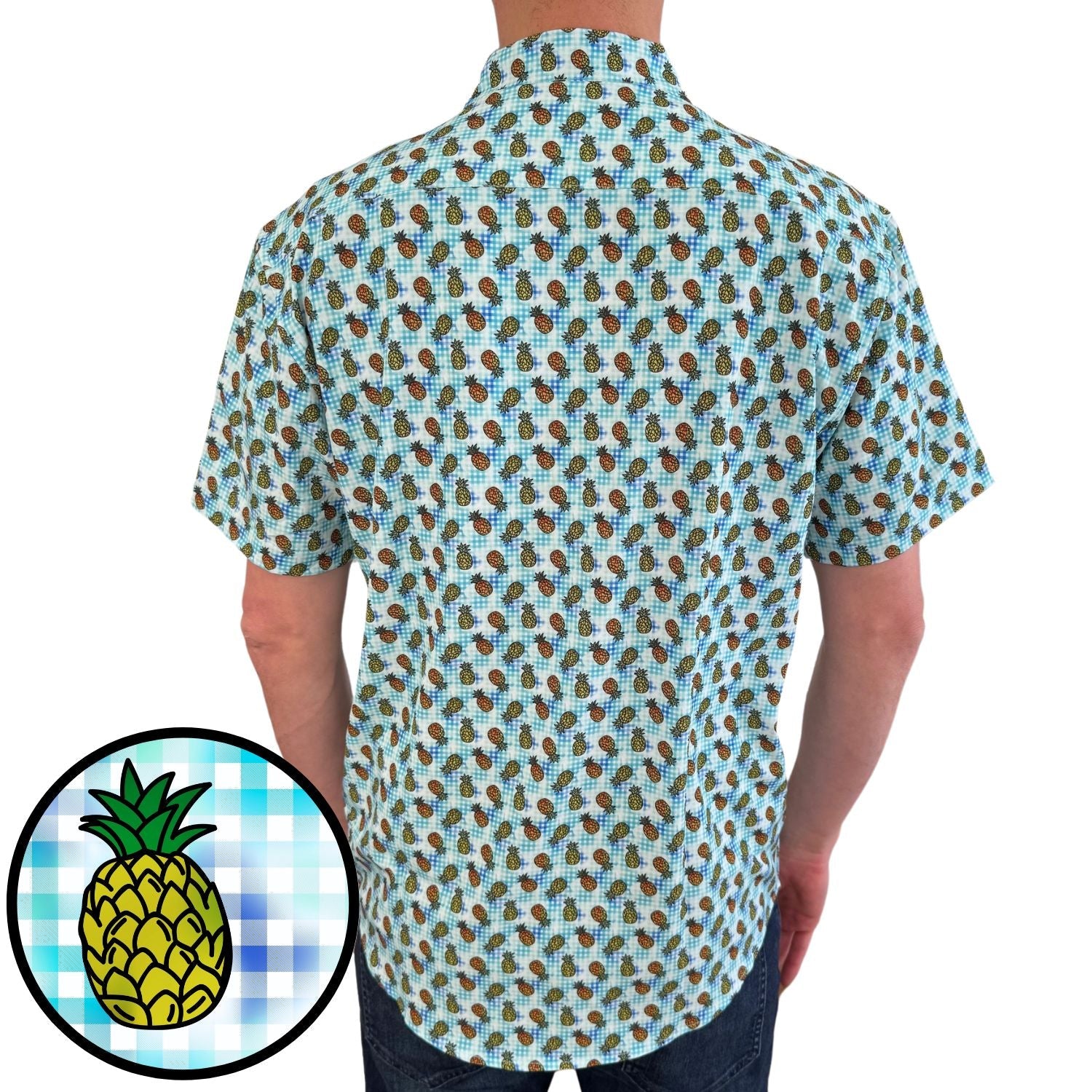 Person wearing a short-sleeve shirt with pineapple pattern on a white background