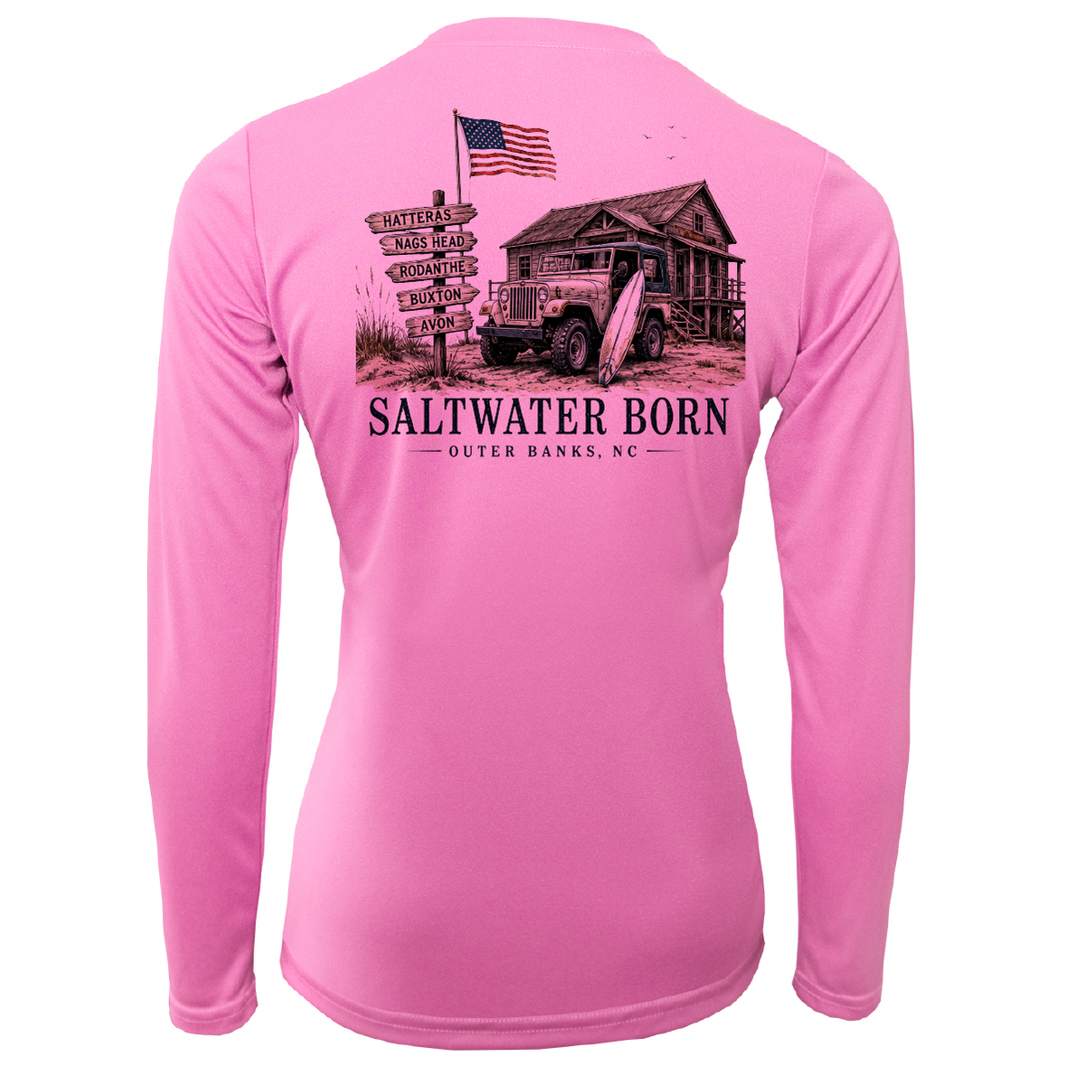 A pink long-sleeve performance shirt shown from the back, featuring a large graphic print of a rustic cabin, an American flag, an old jeep, and a signpost with 'SALTWATER BORN OUTER BANKS, NC' text.