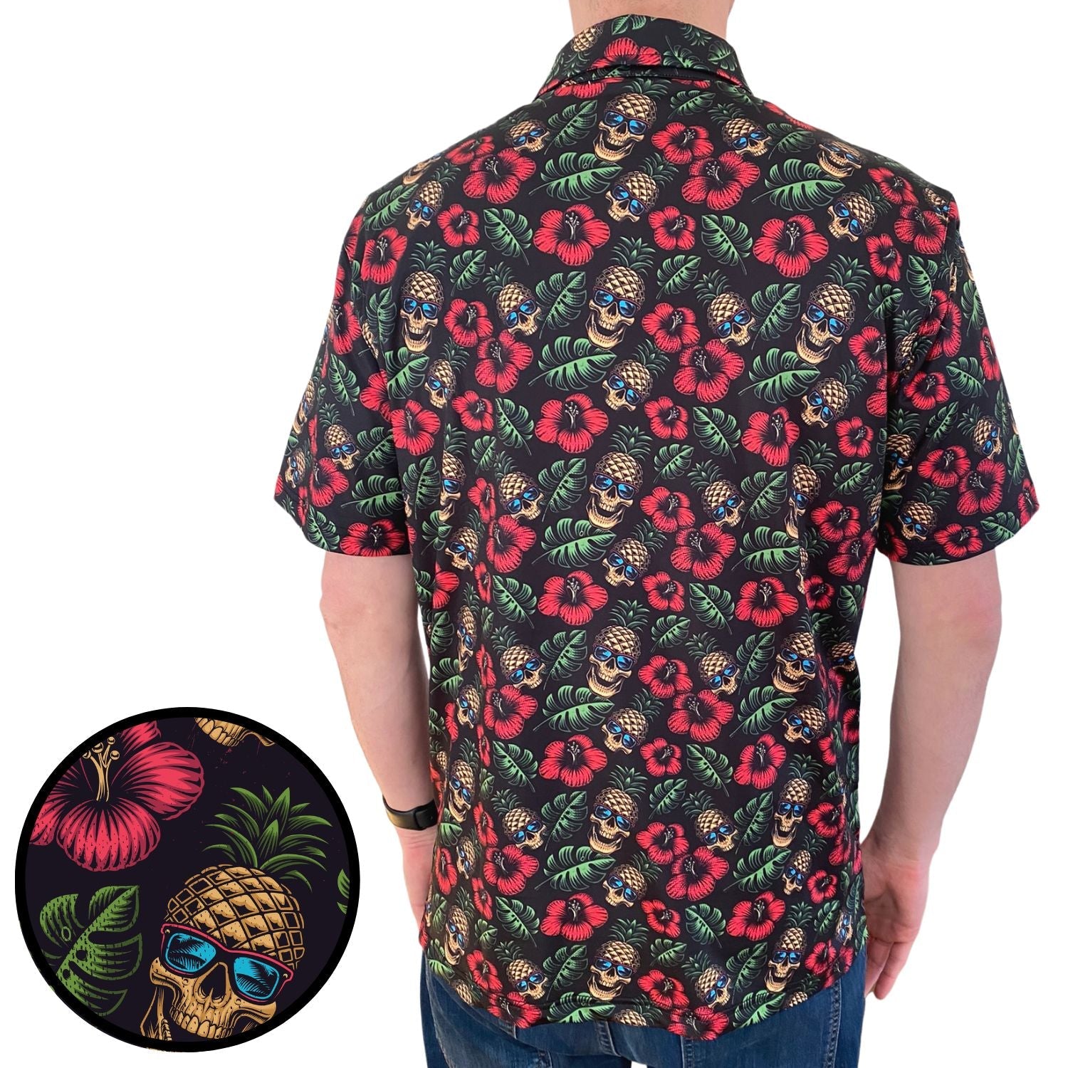 Person wearing a colorful patterned shirt with skull and flower design on a white background