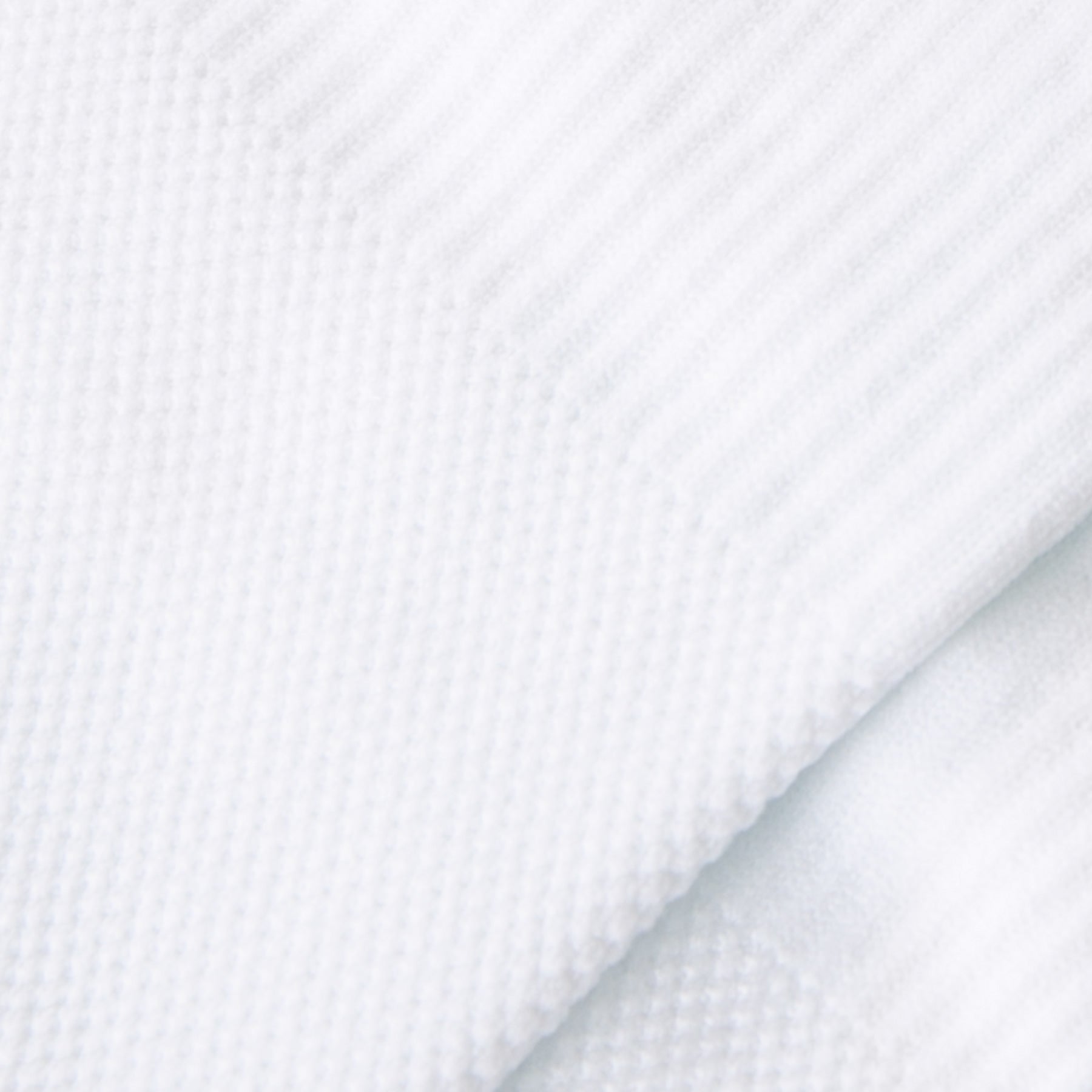 Close-up of white fabric with a subtle pattern
