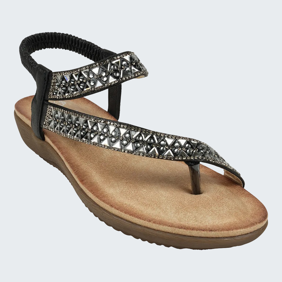 Beige sandal with decorative straps on a white background
