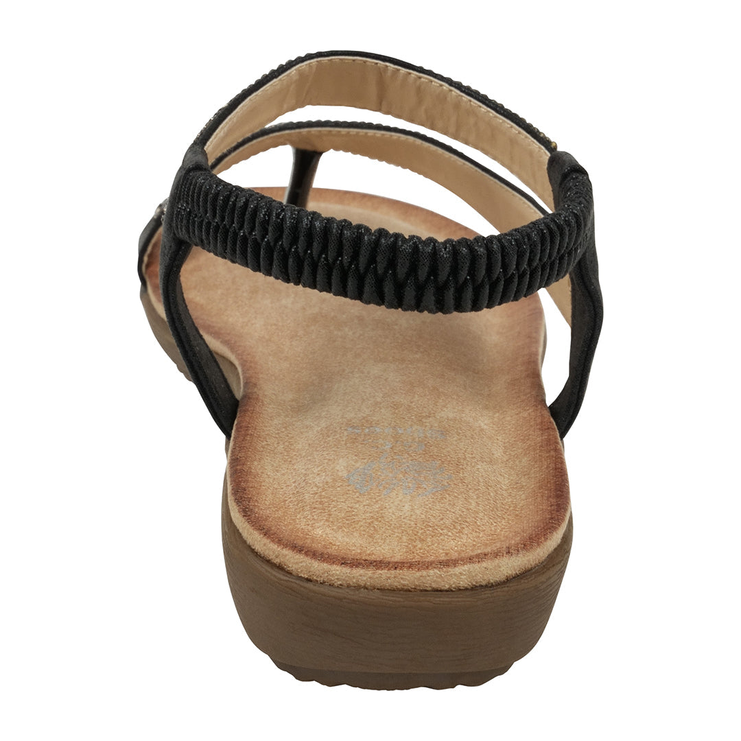 Black sandal with a brown sole on a white background