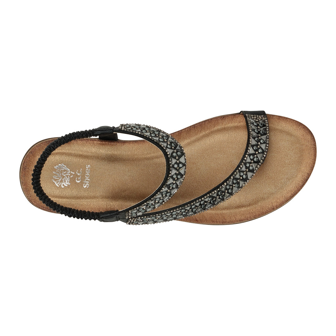 Brown sandal with decorative strap on a white background