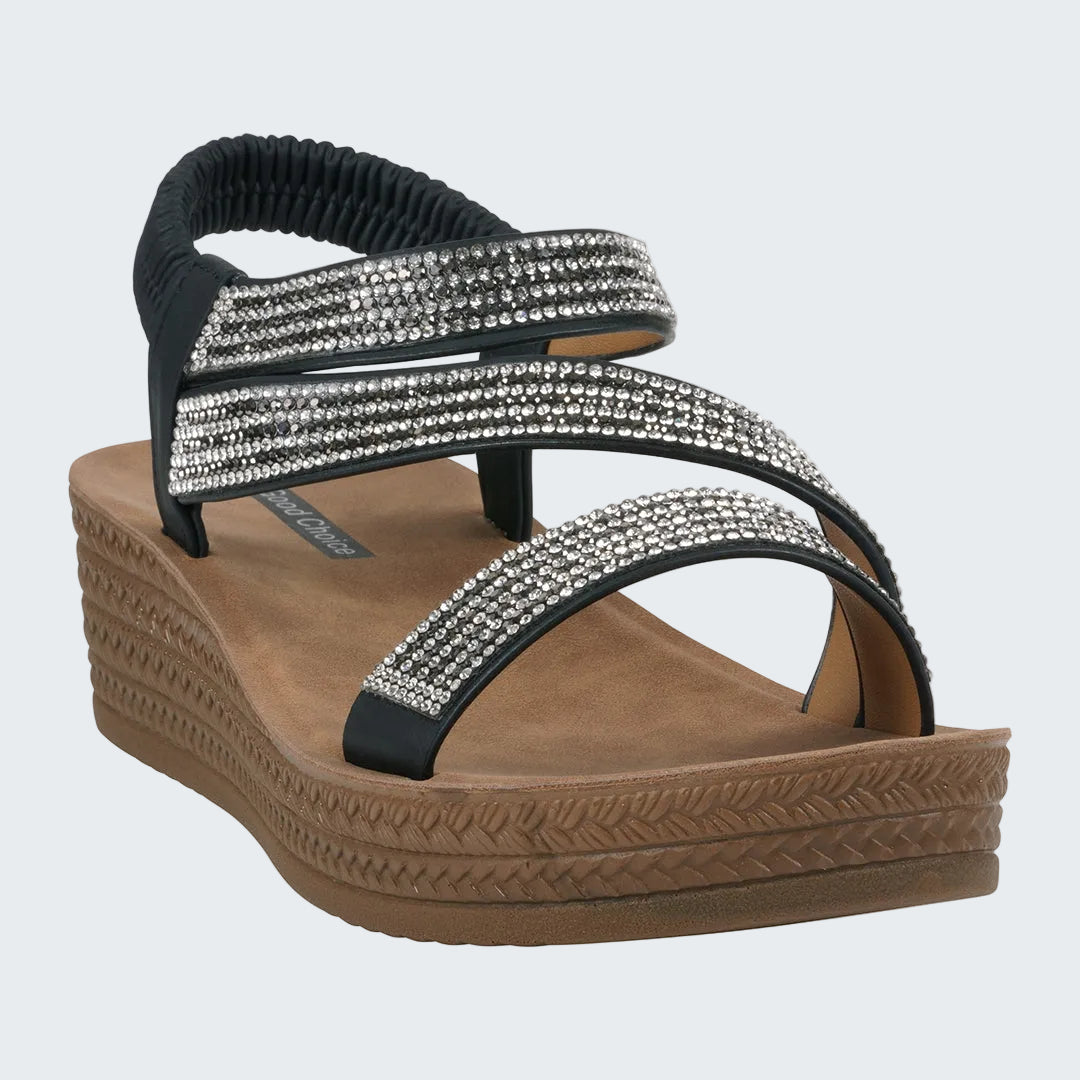 Black and brown sandal with rhinestone embellishments on a white background