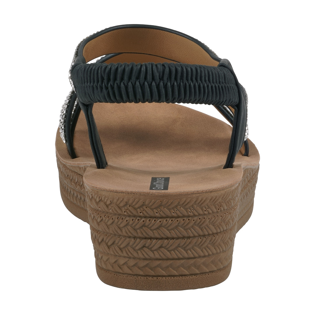 Brown sandal with black straps on a white background