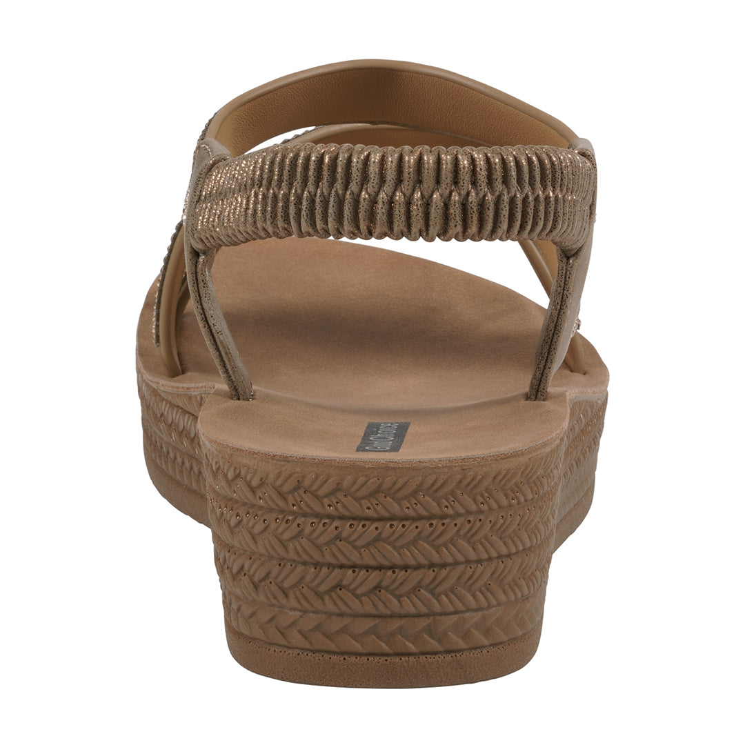 Brown sandal with textured straps on a white background