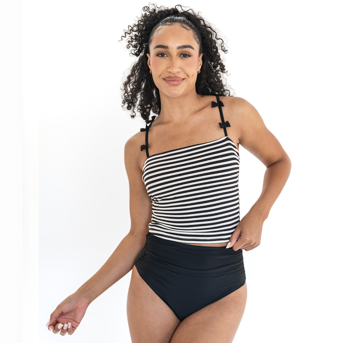 Woman wearing a black and white striped tankini on a white background