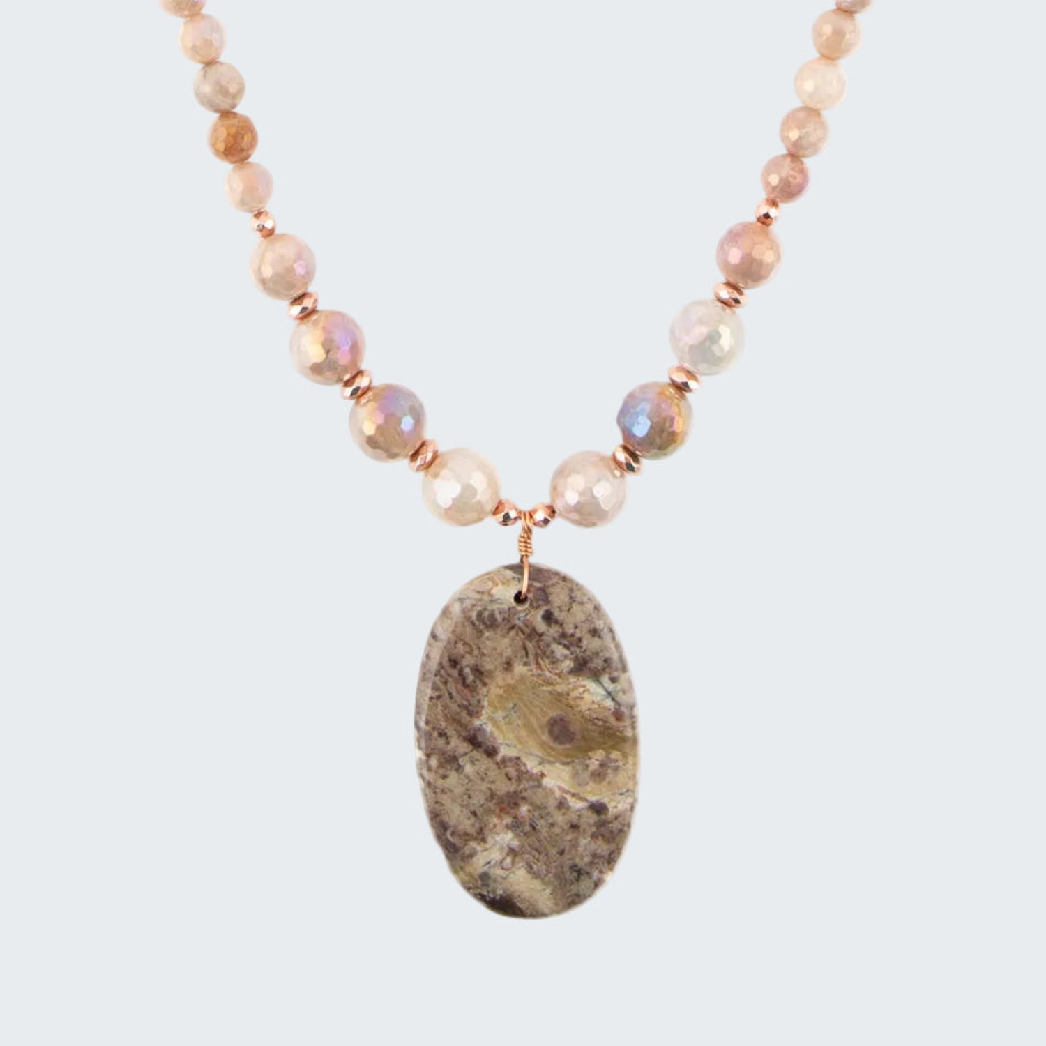 Necklace with beaded chain and large stone pendant on a white background