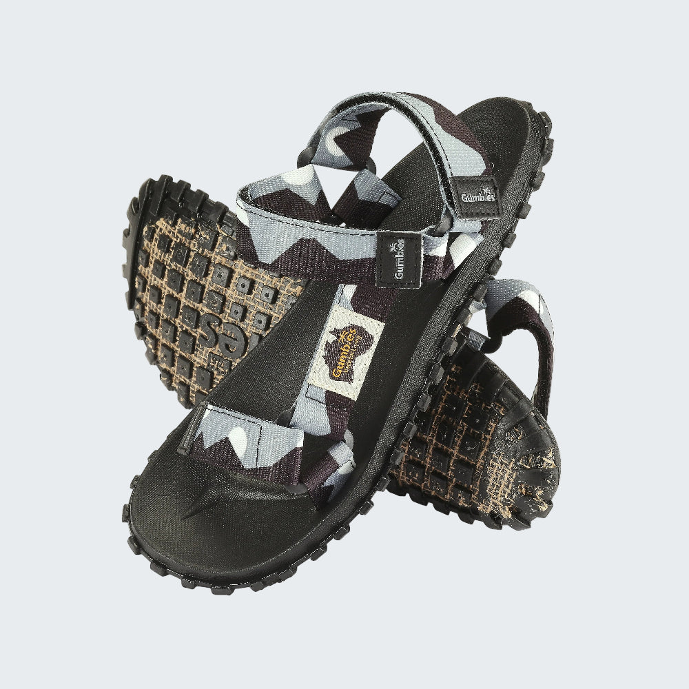 Pair of black and patterned sandals with a visible brand logo on a white background