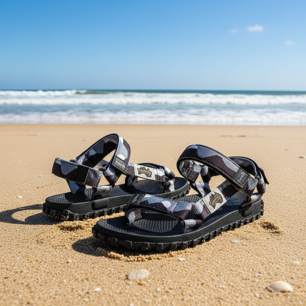 Black and gray sandals with unique design on a white background