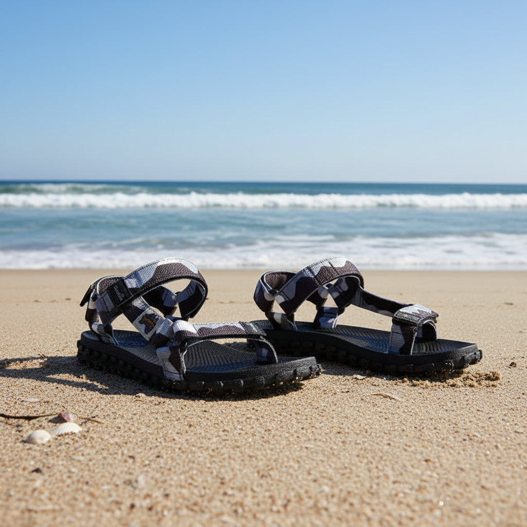 Black and gray sandals with unique design on a white background