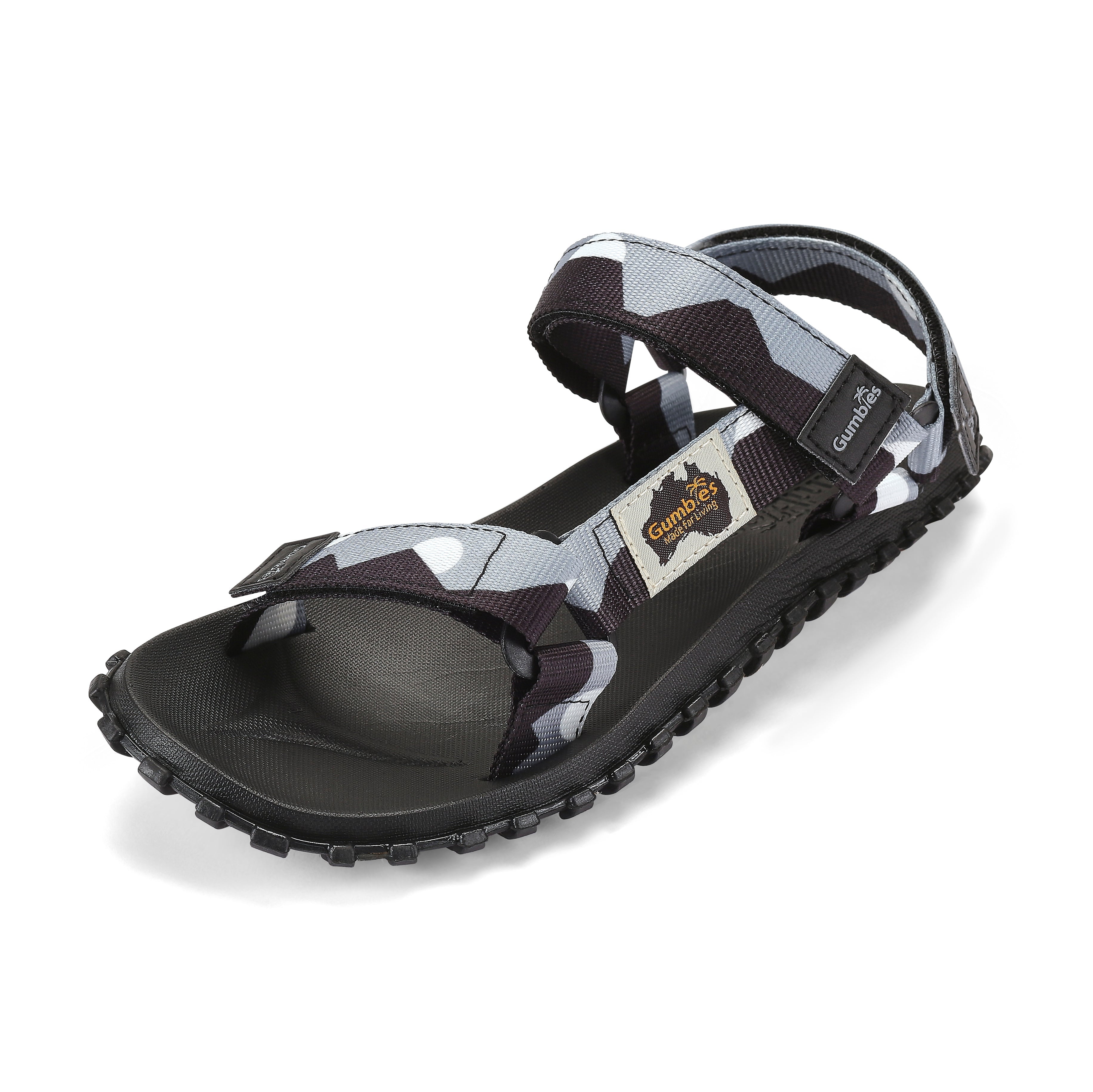 Black and gray sandal with a patterned strap on a white background