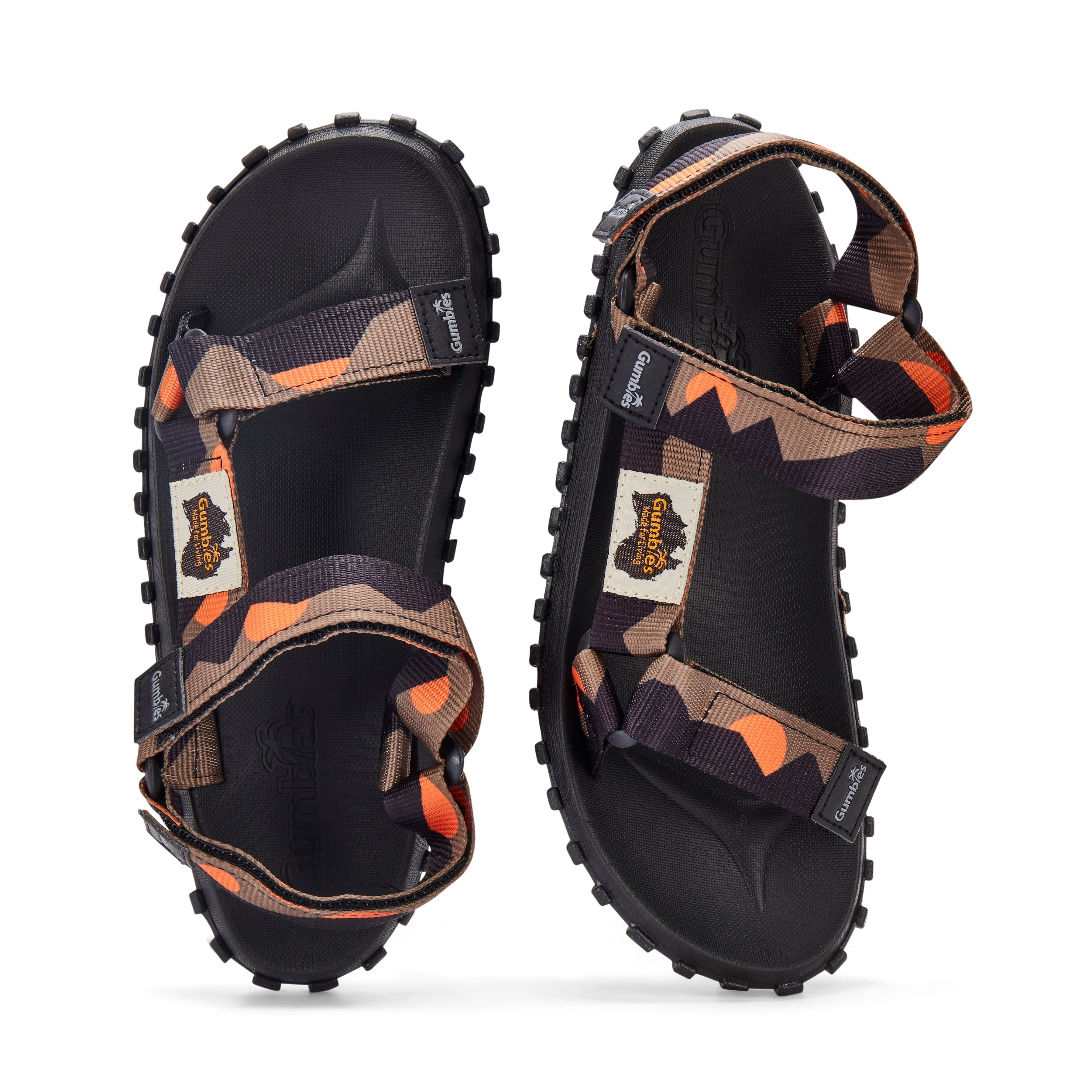 Black sandals with orange and brown accents on a white background