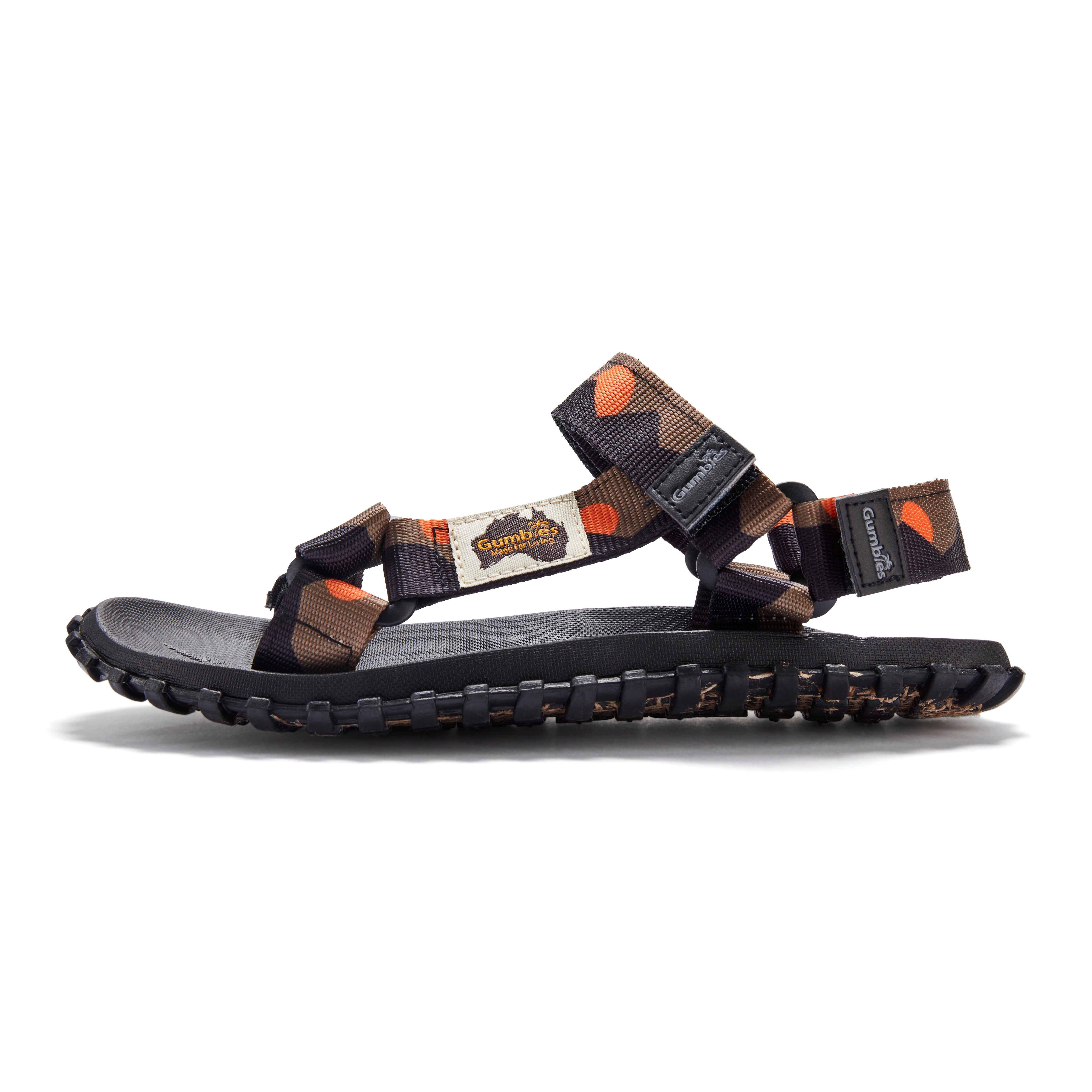 Black sandal with orange and brown straps on a white background