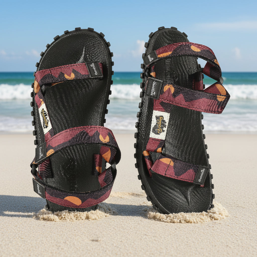 Black sandals with patterned straps on a white background
