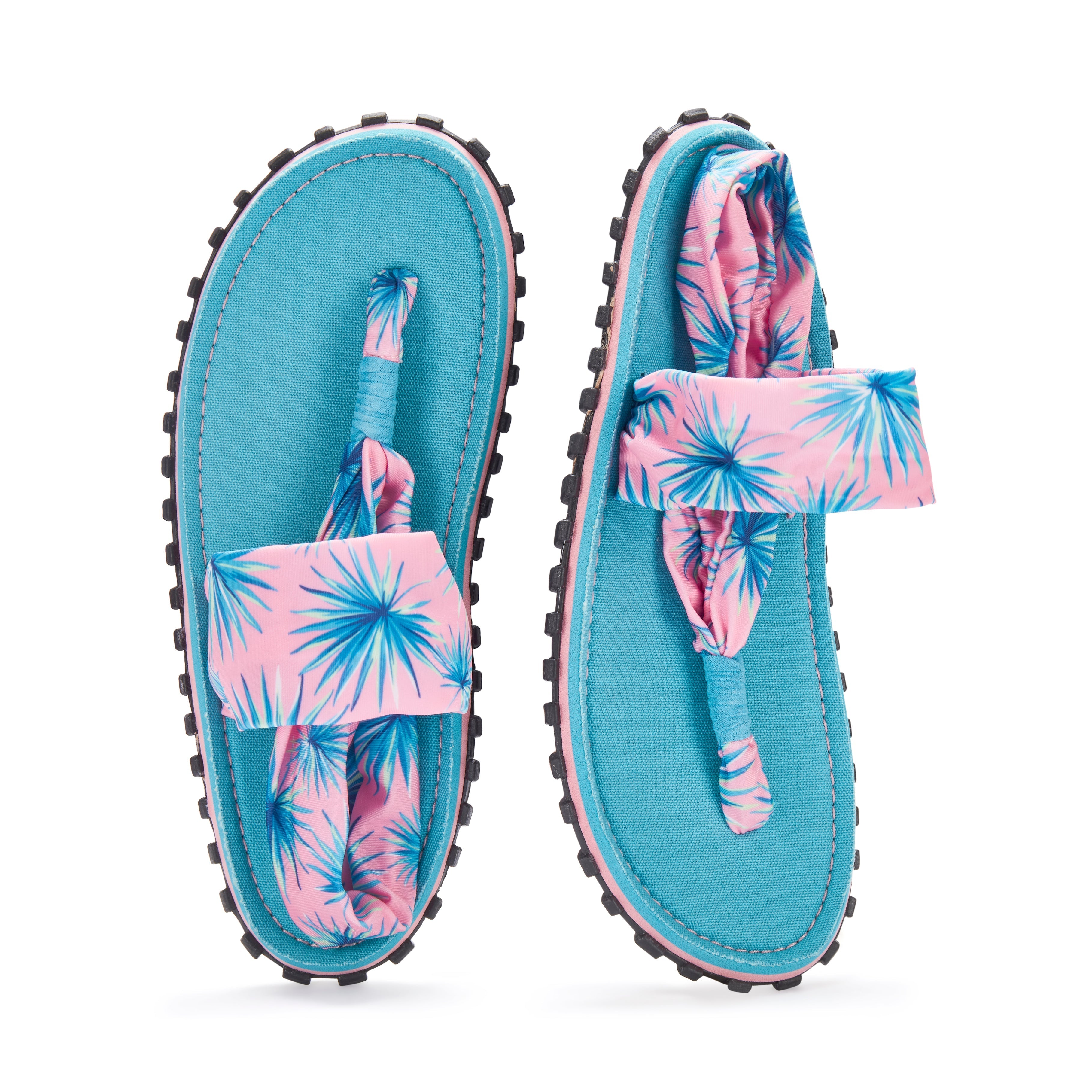 Blue sandals with pink and blue floral straps on a white background