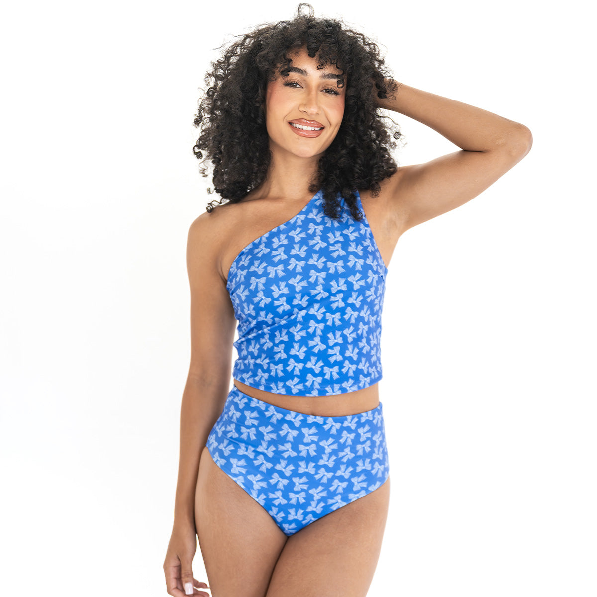 Woman wearing a blue floral one-shoulder bikini on a white background