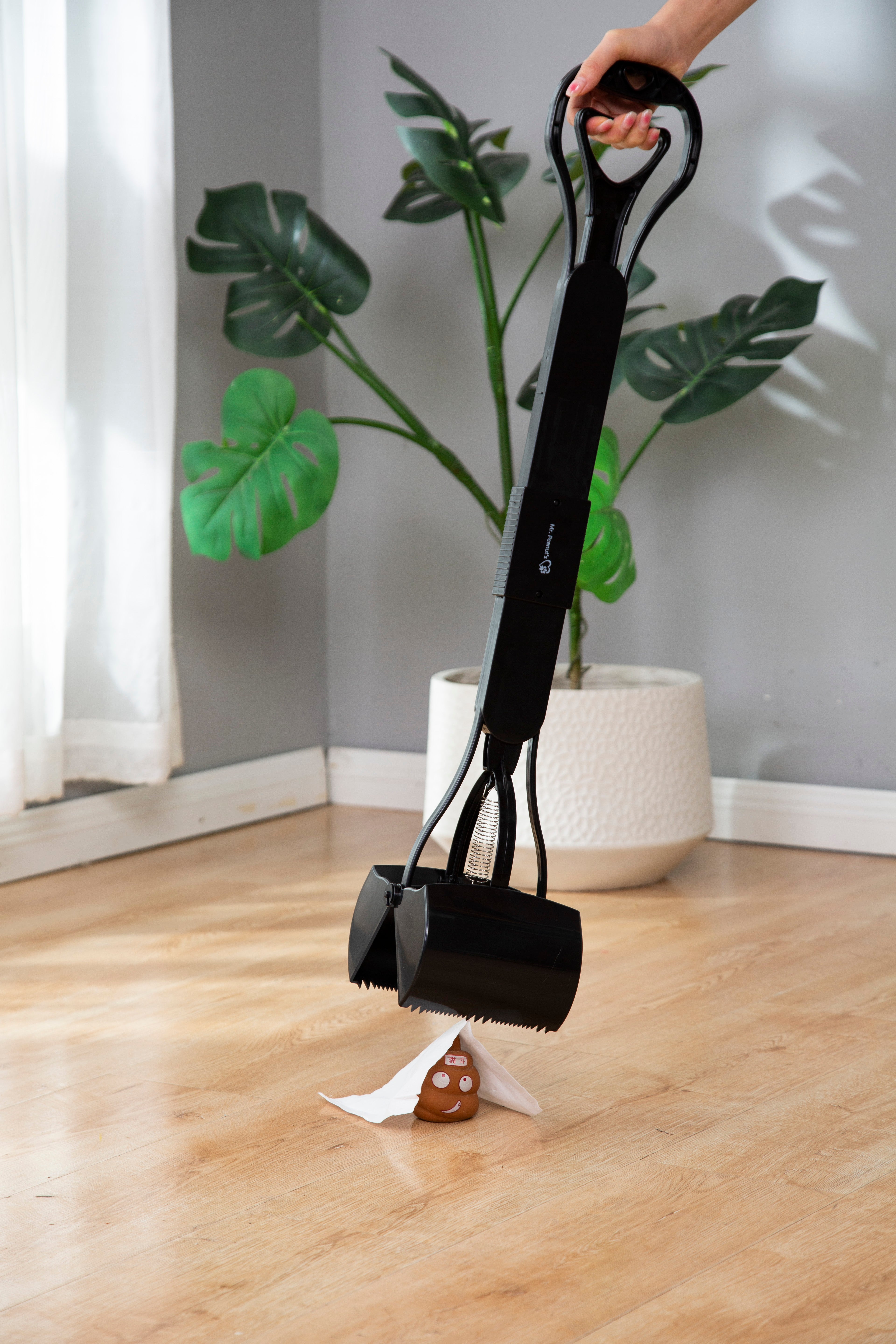 Pet grooming tool with a paw-shaped container on a wooden floor.