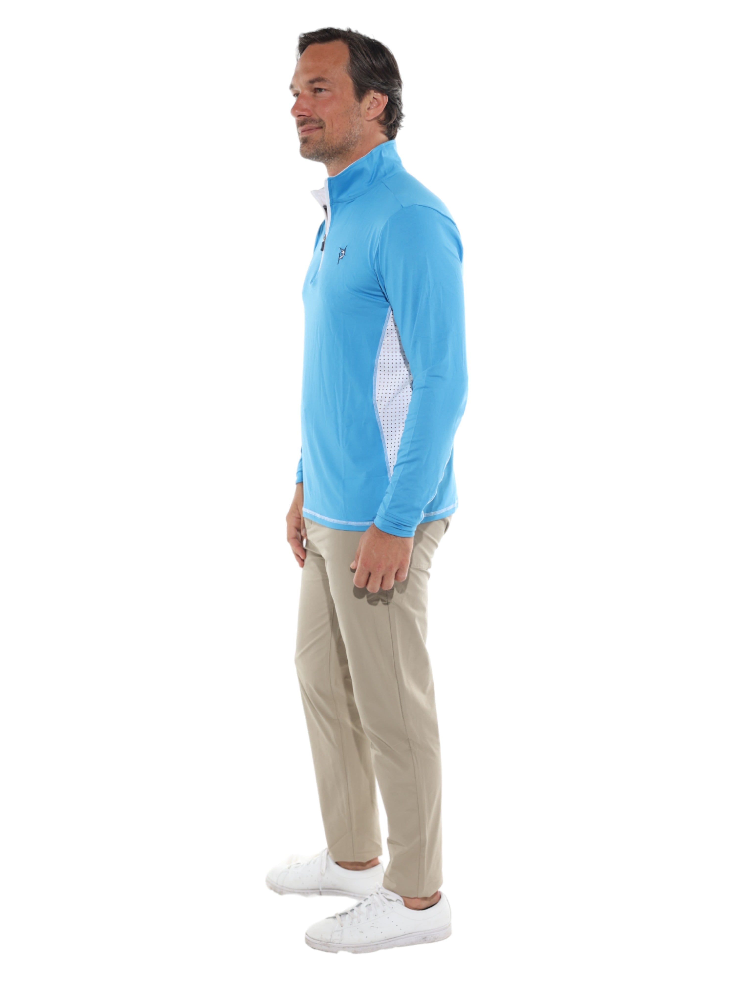 Man wearing a blue long-sleeve shirt and beige pants on a white background