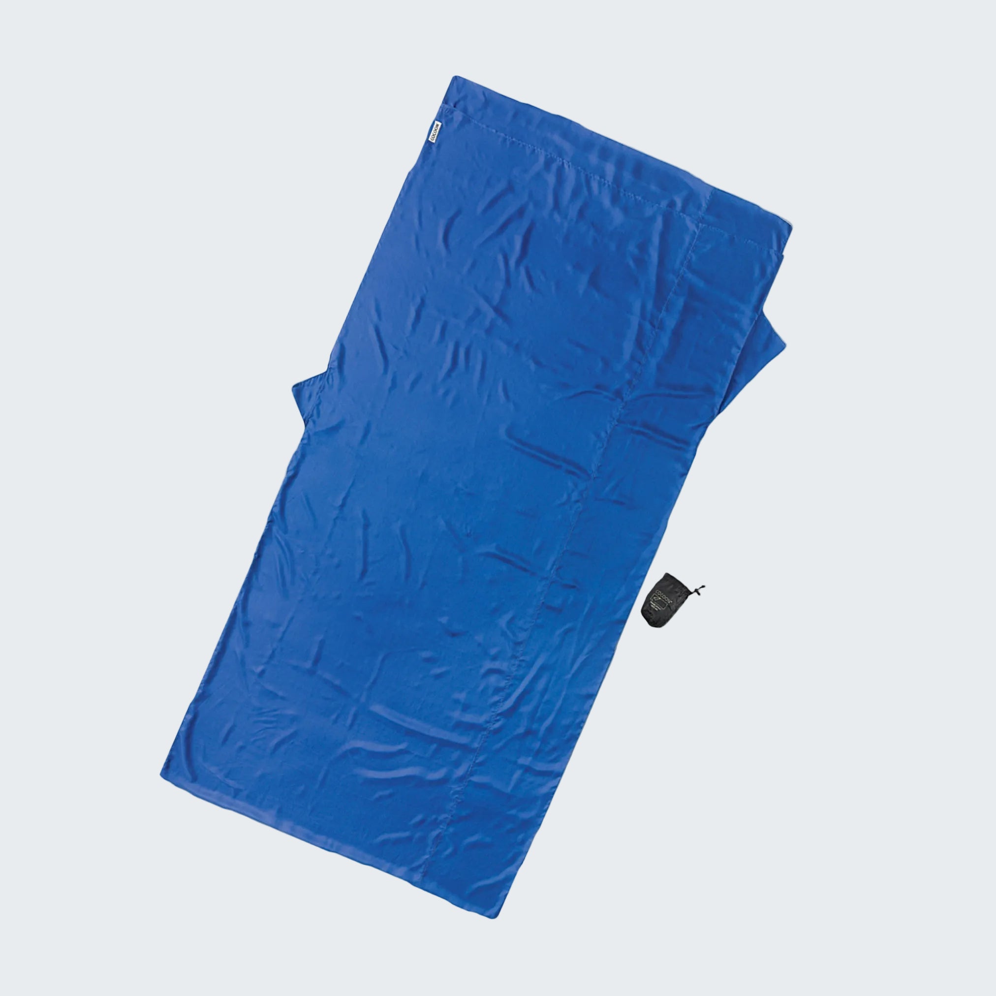Blue towel with a black tag on a light gray background