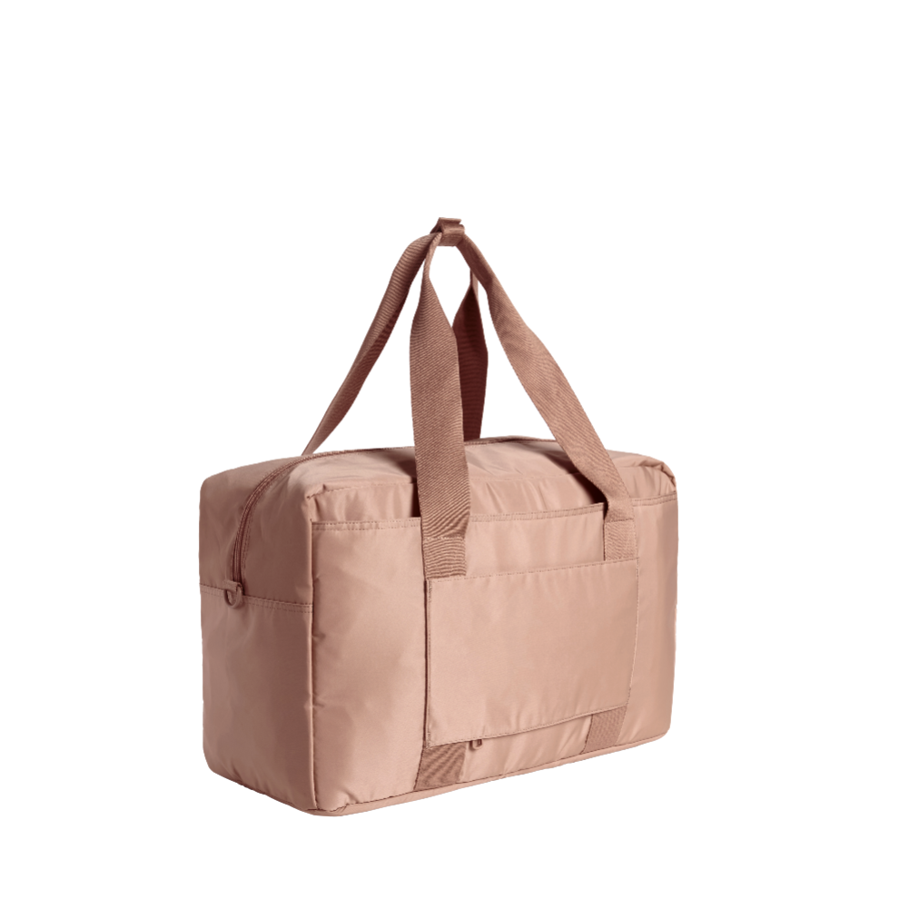 Beige duffel bag with brown straps on a white background