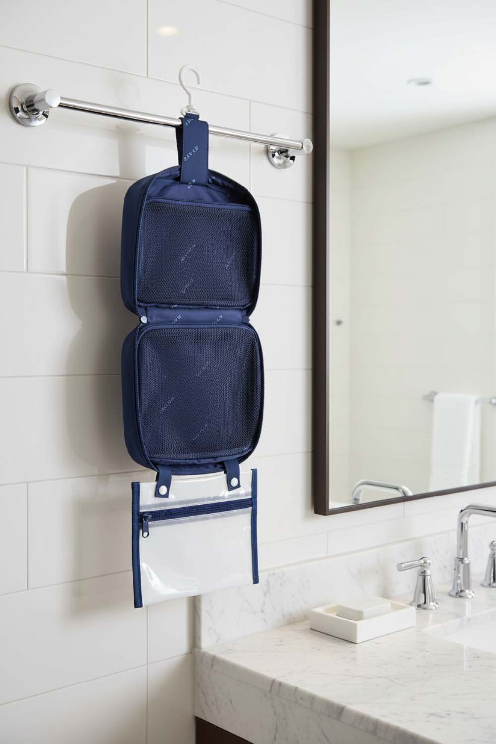 Blue hanging toiletry bag with clear window on a white background